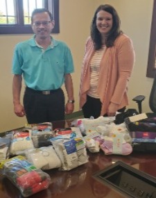 Employees pictured with new socks and underwear collected for The Drawer organization